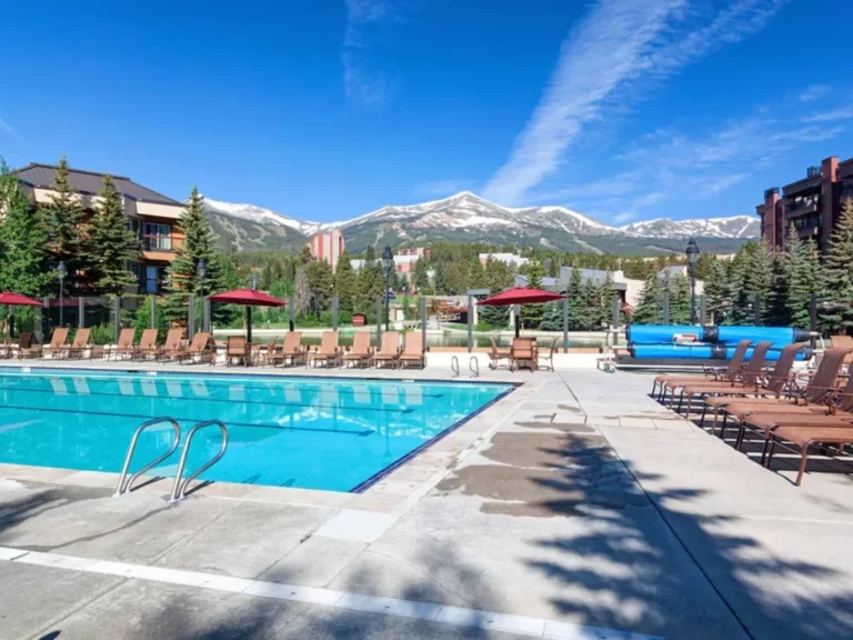 huge hotel pool surrounded by snow-capped mountains
